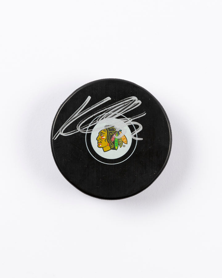 signed Chicago Blackhawks hockey puck signed by Kevin Lankinen - front lay flat