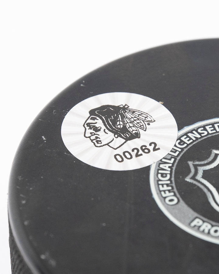 Chicago Blackhawks Kirby Dach signed puck from 2021-22 season - back detail lay flat