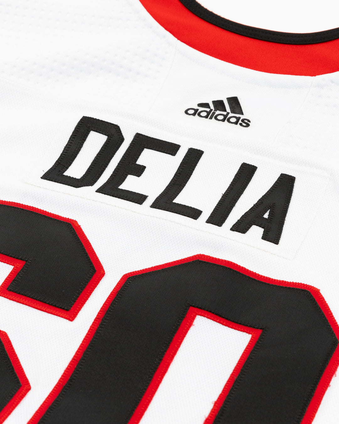 white team issued Chicago Blackhawks jersey with Collin Delia name and number - back detail lay flat