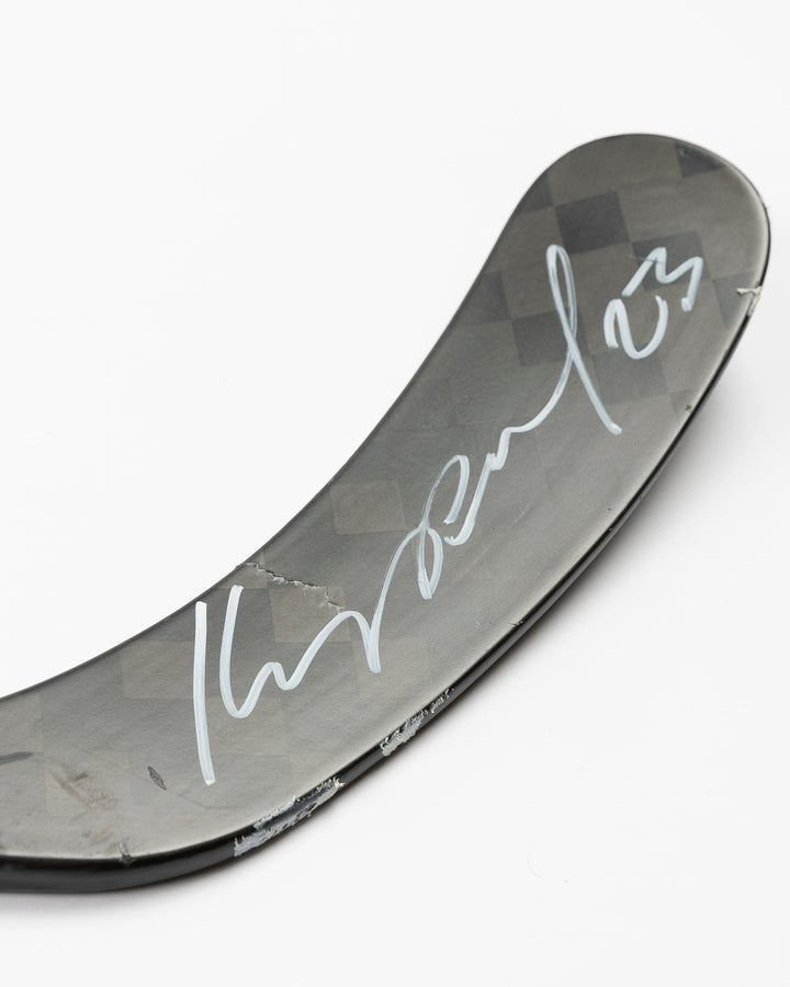 signed and game-used CCM hockey stick of Chicago Blackhawks Philipp Kurashev - autograph detail lay flat 