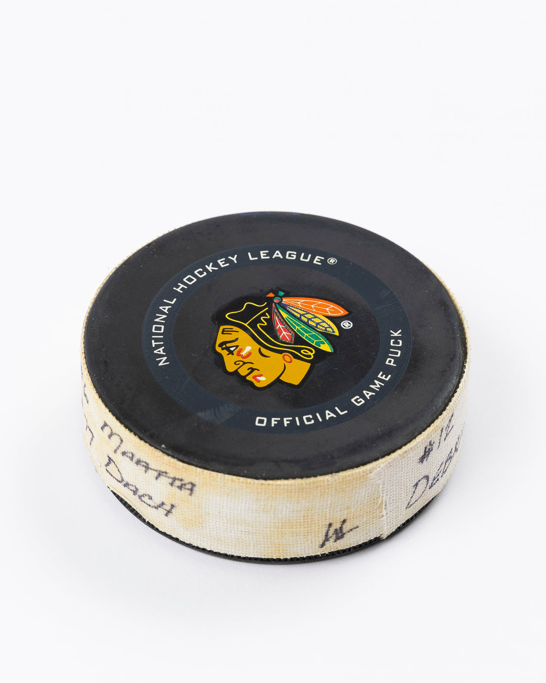 game-used hockey goal puck shot by former Chicago Blackhawks player Alex DeBrincat - angle lay flat