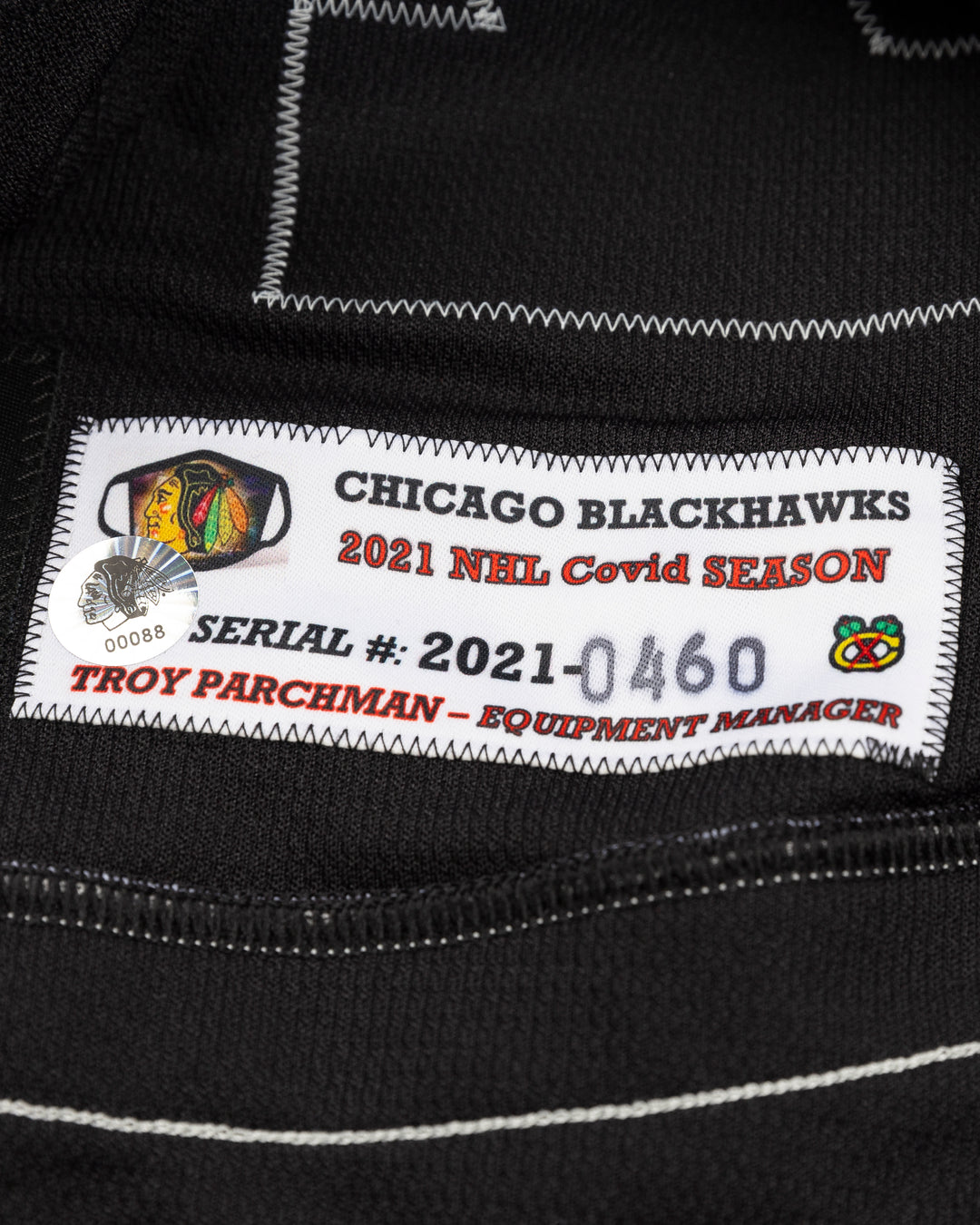 black alternate team-issued Chicago Blackhawks jersey of former player Kirby Dach - tag detail lay flat