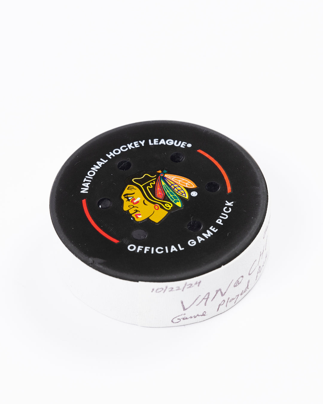 game used hockey puck from the Chicago Blackhawks game on October 22, 2024 - front angled lay flat