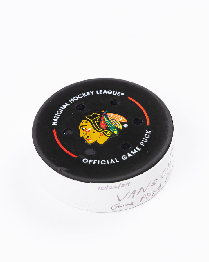 game used hockey puck from the Chicago Blackhawks game on October 22, 2024 - front angled lay flat