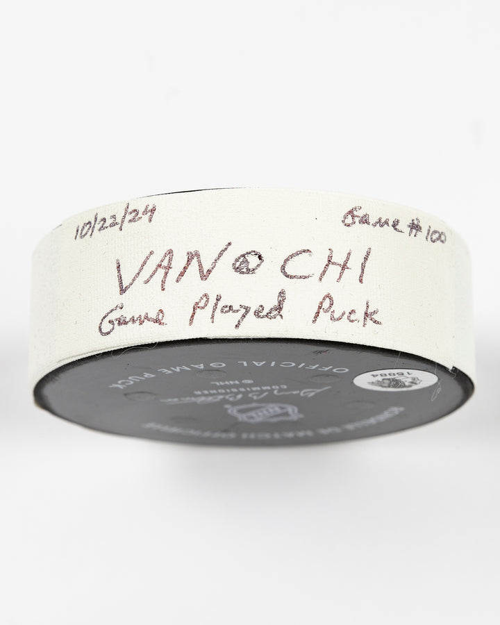 game used hockey puck from the Chicago Blackhawks game on October 22, 2024 - side lay flat