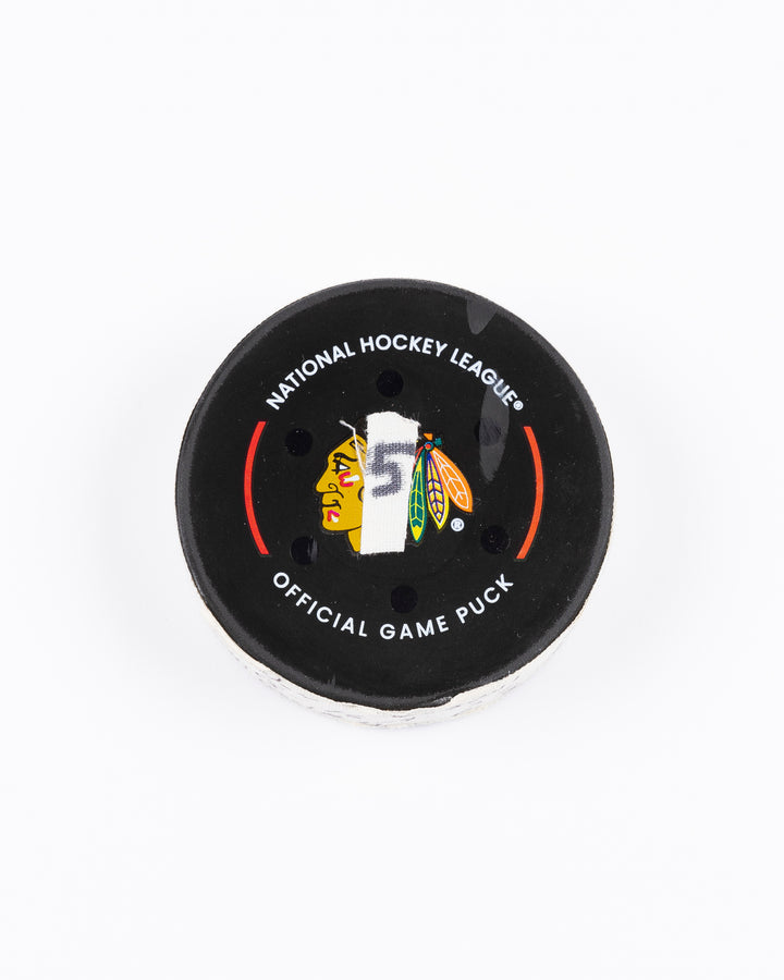 game-used hockey goal puck scored by Chicago Blackhawks player Jason Dickinson - front lay flat