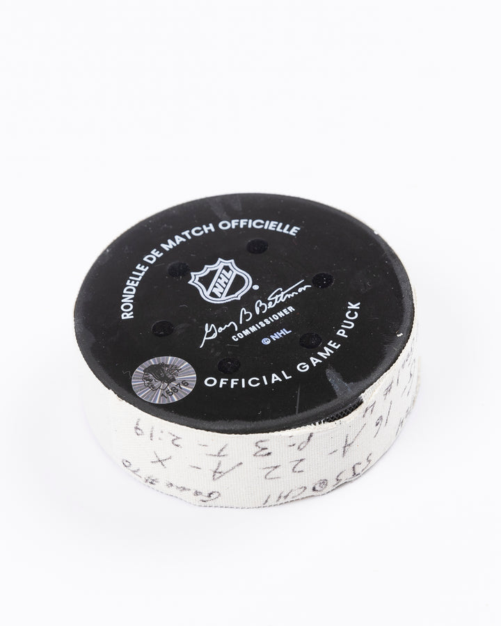 game-used hockey goal puck scored by Chicago Blackhawks player Jason Dickinson - back angled lay flat