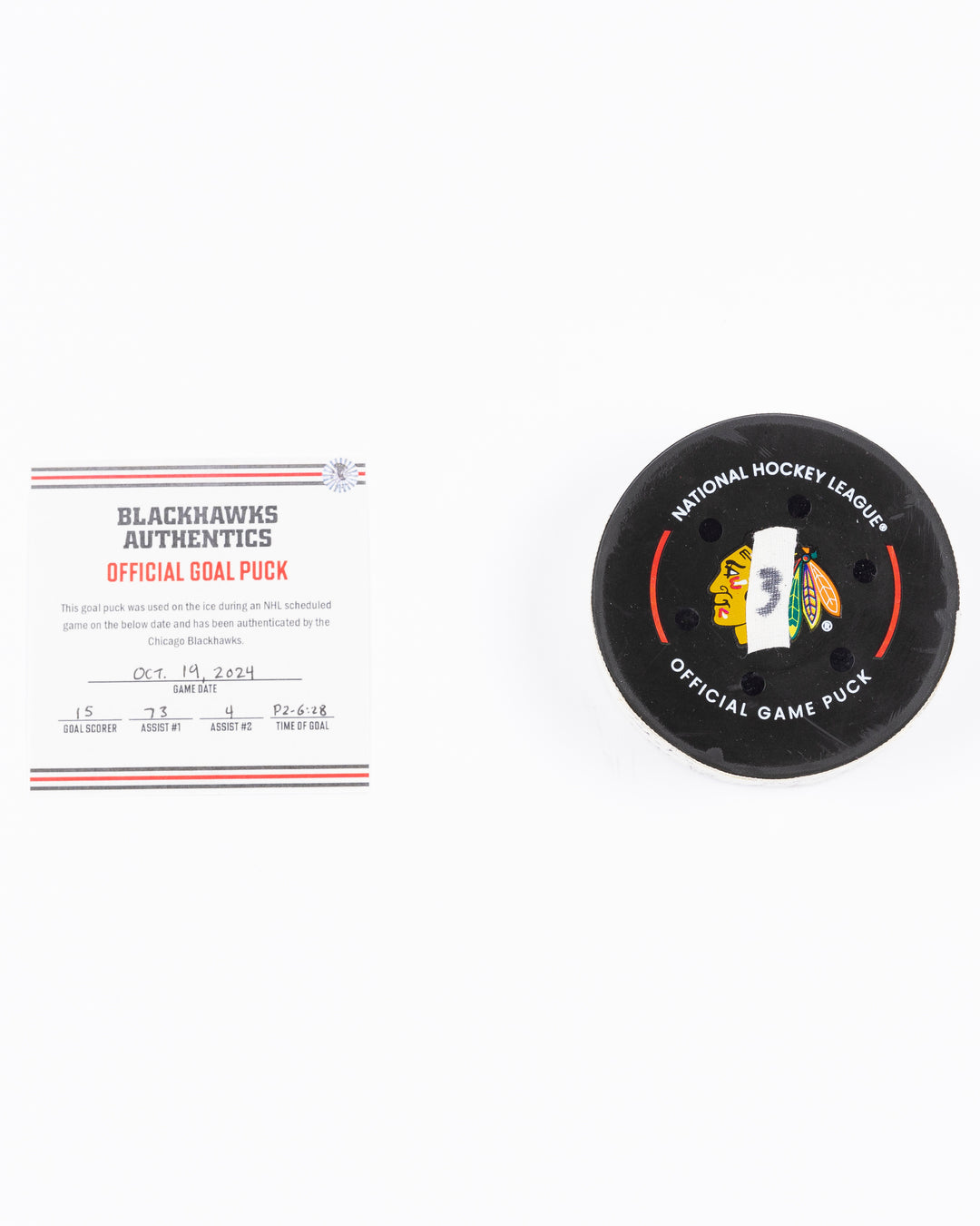 game-used hockey goal puck scored by Chicago Blackhawks player Craig Smith on October 19, 2024 - front lay flat with certificate