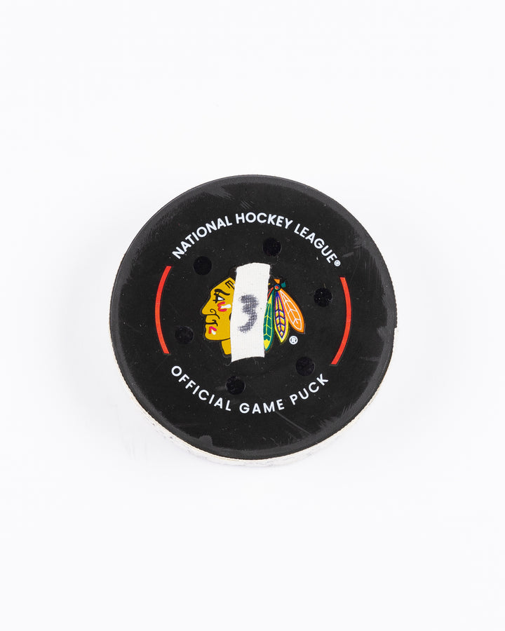 game-used hockey goal puck scored by Chicago Blackhawks player Craig Smith on October 19, 2024 - front lay flat