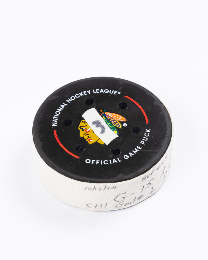 game-used hockey goal puck scored by Chicago Blackhawks player Craig Smith on October 19, 2024 - front angled lay flat