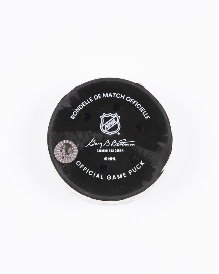 game-used hockey goal puck scored by Chicago Blackhawks player Craig Smith on October 19, 2024 - back lay flat