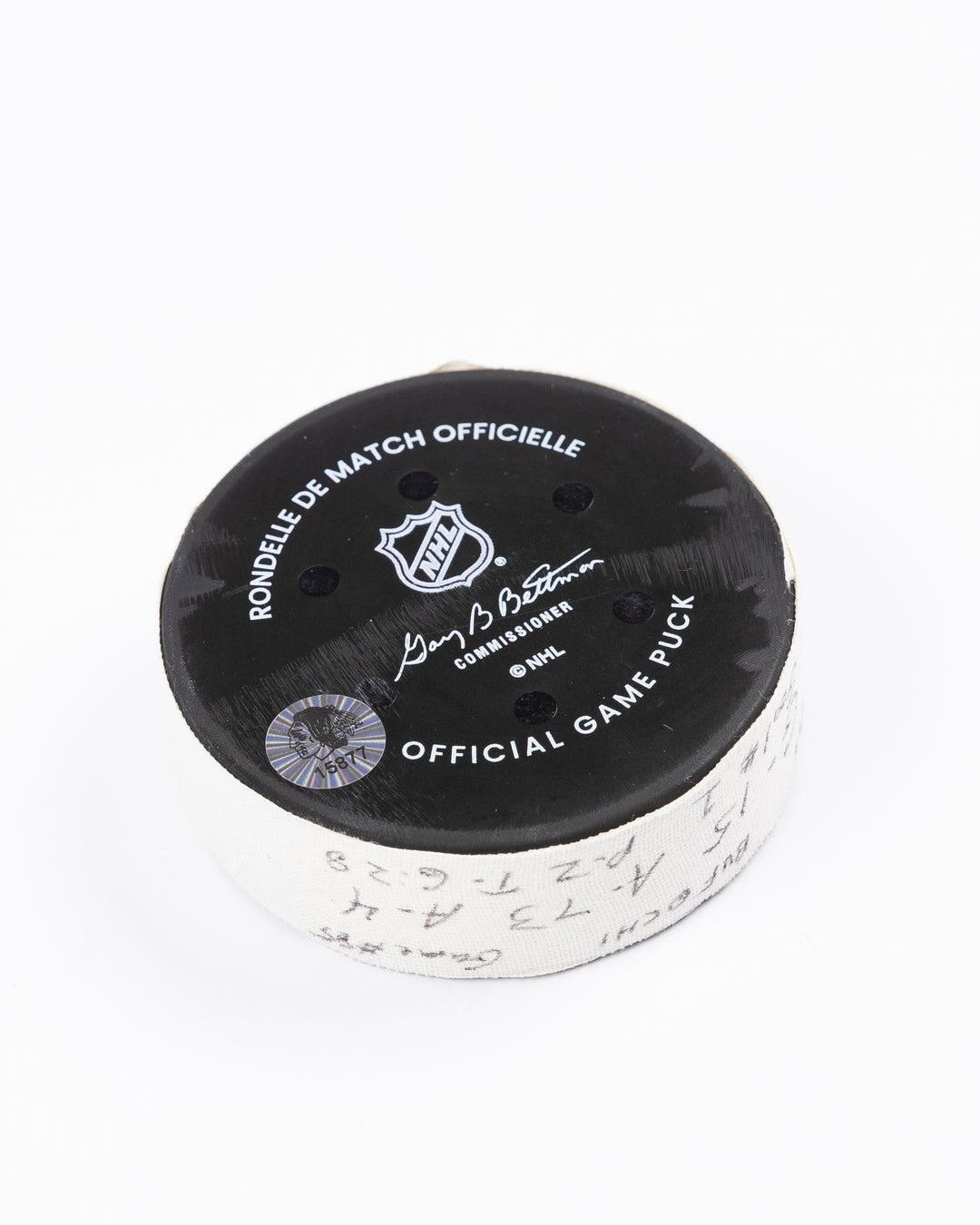 game-used hockey goal puck scored by Chicago Blackhawks player Craig Smith on October 19, 2024 - back angled lay flat