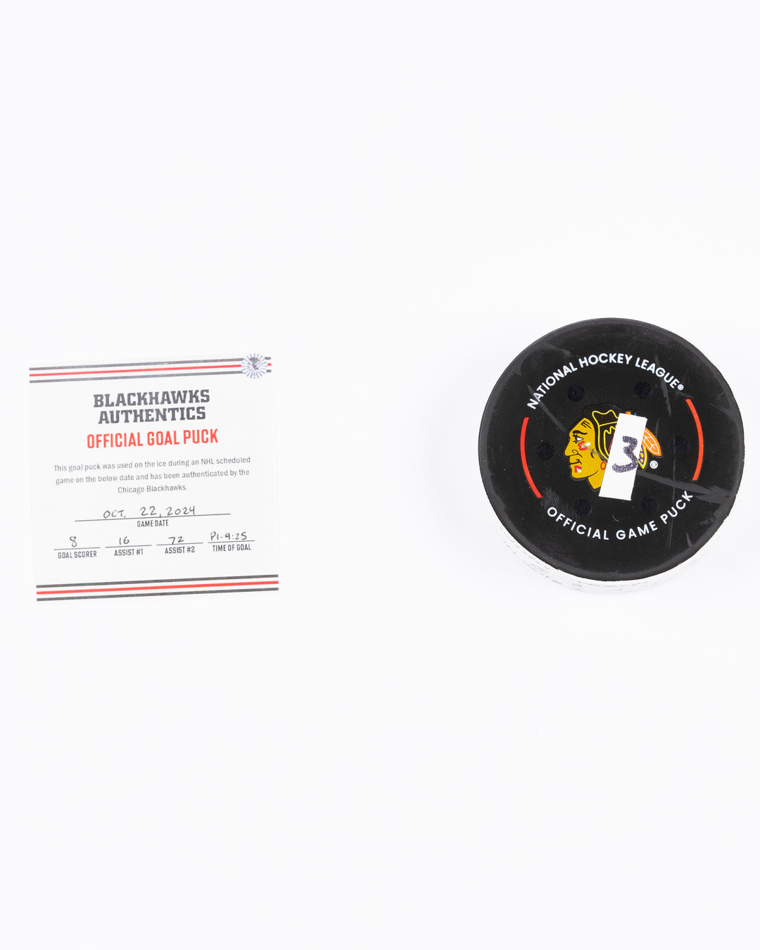 game used hockey goal puck scored by Chicago Blackhawks player Ryan Donato during game on October 22, 2024 - front lay flat with certificate