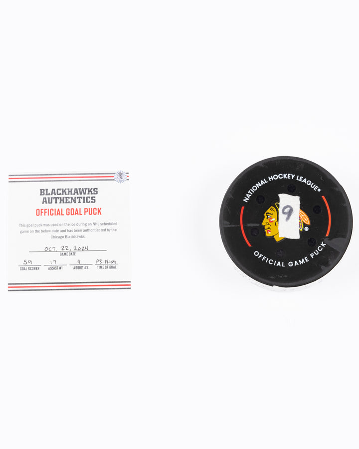 game used hockey goal puck scored by Chicago Blackhawks player Tyler Bertuzzi during game on October 22, 2024 - front lay flat with certificate