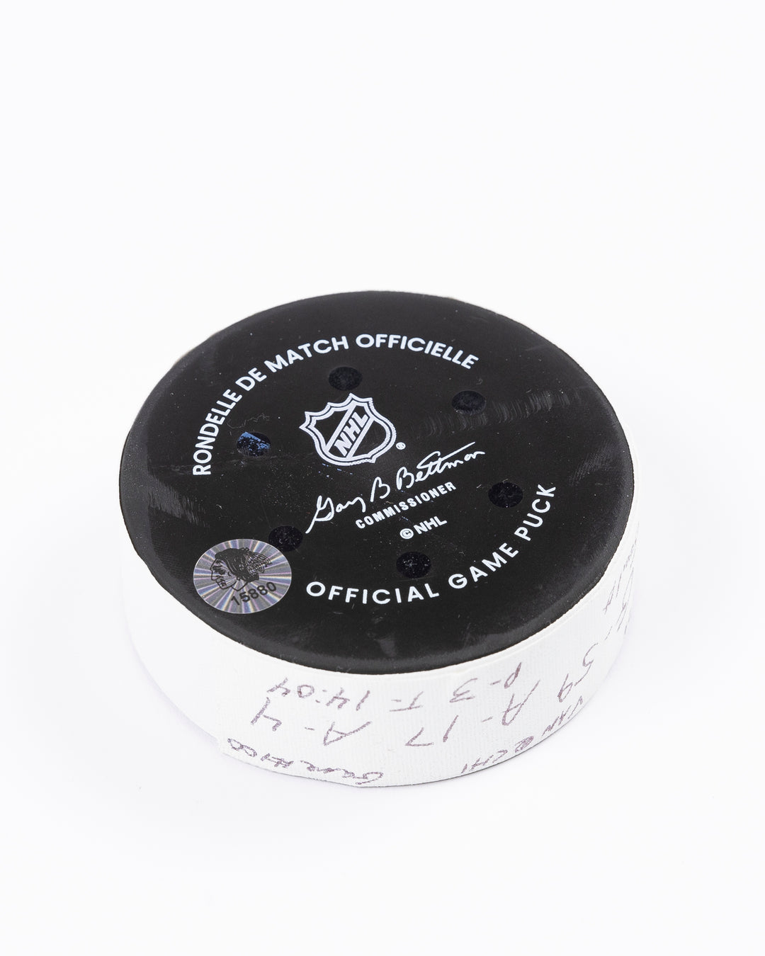 game used hockey goal puck scored by Chicago Blackhawks player Tyler Bertuzzi during game on October 22, 2024 - back angled lay flat