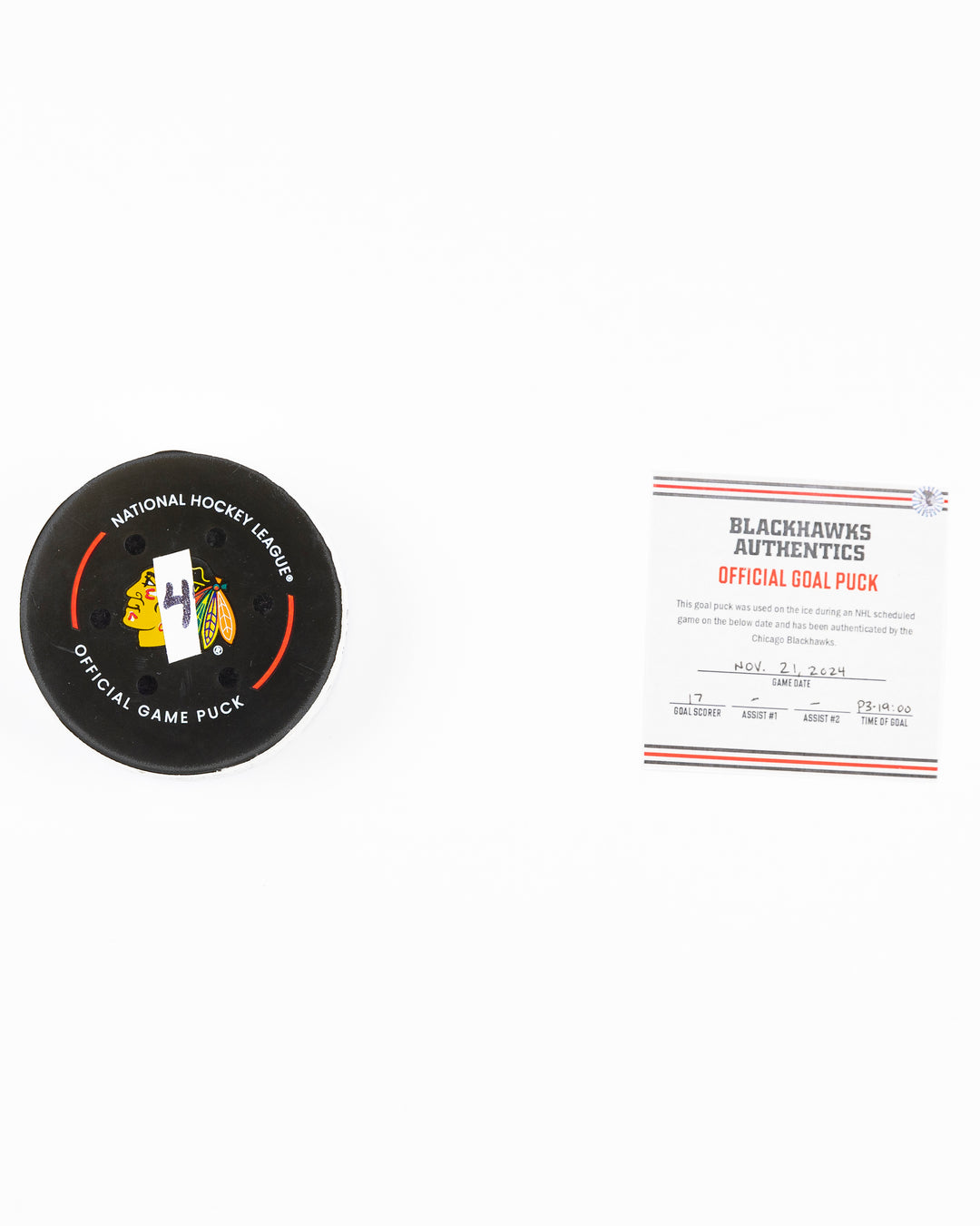 official Chicago Blackhawks hockey goal puck scored by Nick Foligno against the Florida Panthers in November 2024 - front lay flat of puck and certificate