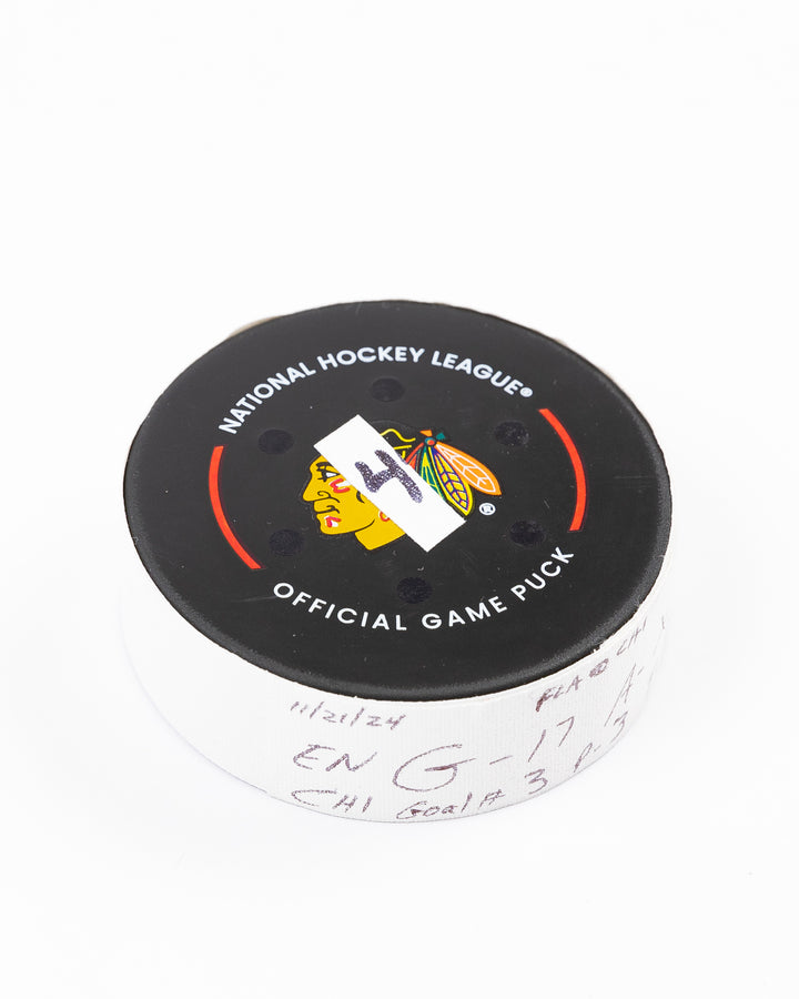 official Chicago Blackhawks hockey goal puck scored by Nick Foligno against the Florida Panthers in November 2024 - front angled lay flat