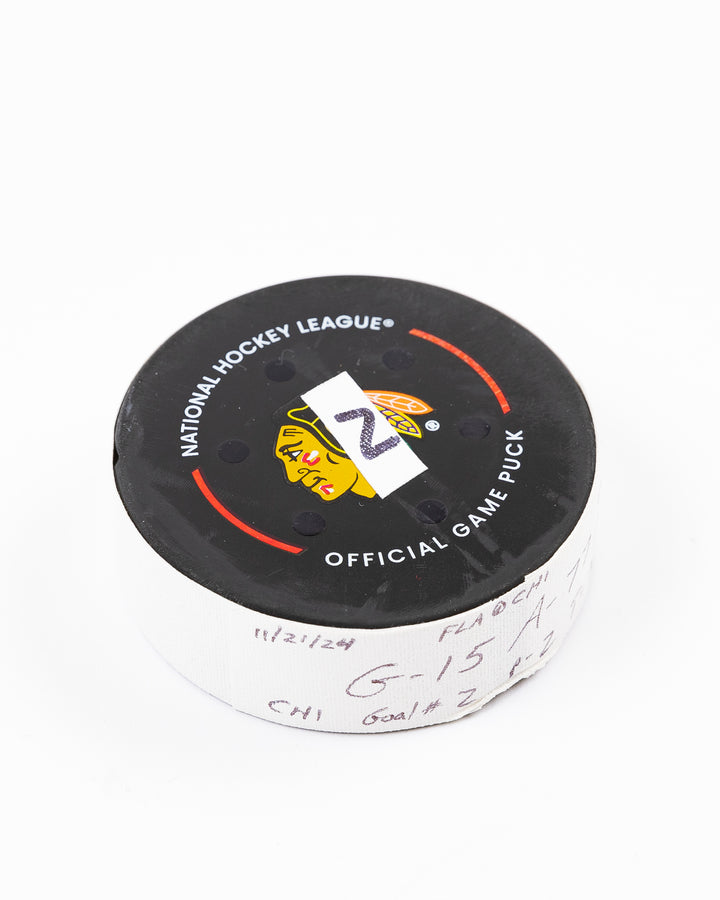 official Chicago Blackhawks hockey goal puck scored by Craig Smith against the Florida Panthers in November 2024 - front angled lay flat