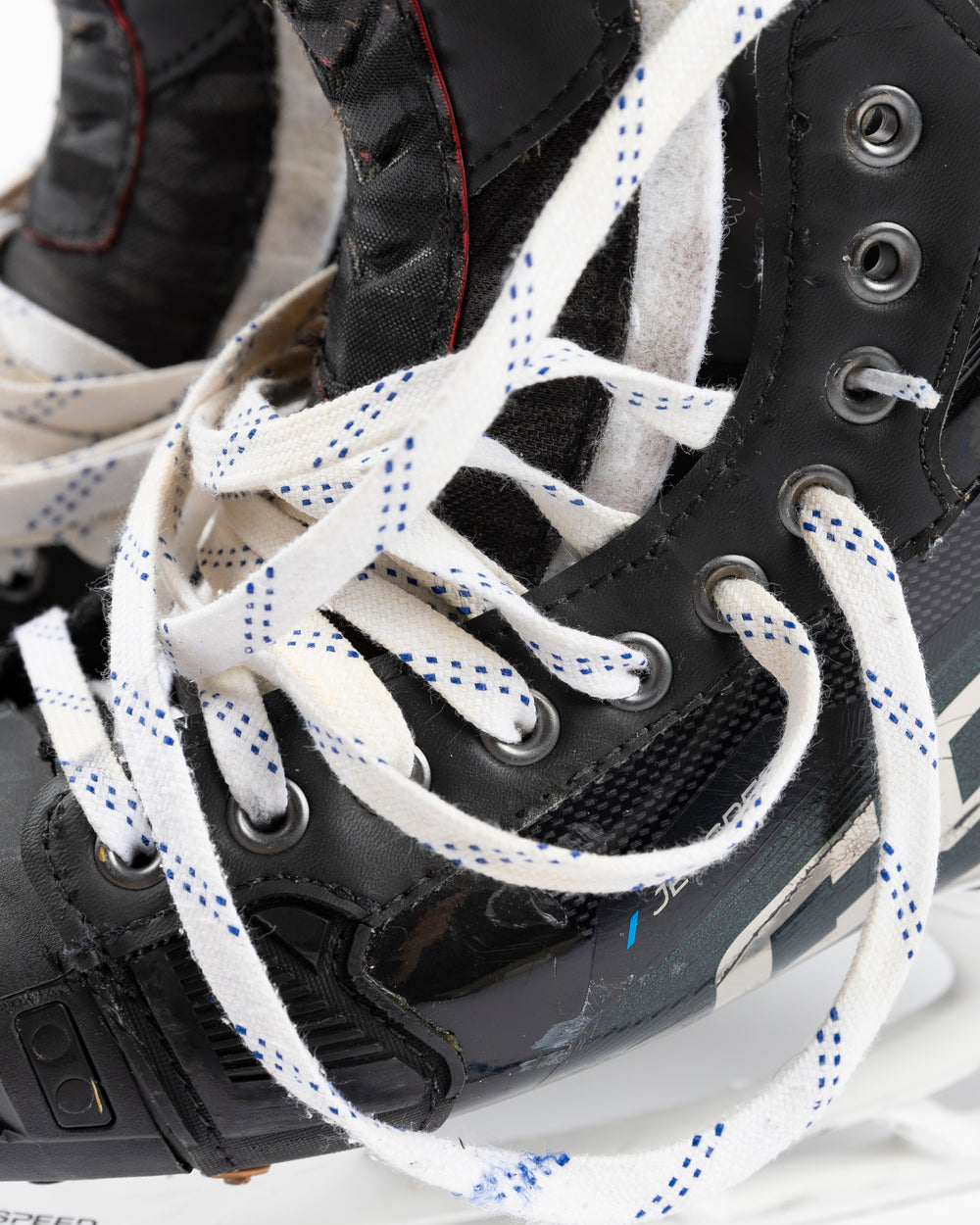 black CCM hockey skates worn and used by Chicago Blackhawks player Jason Dickinson - lace detail lay flat