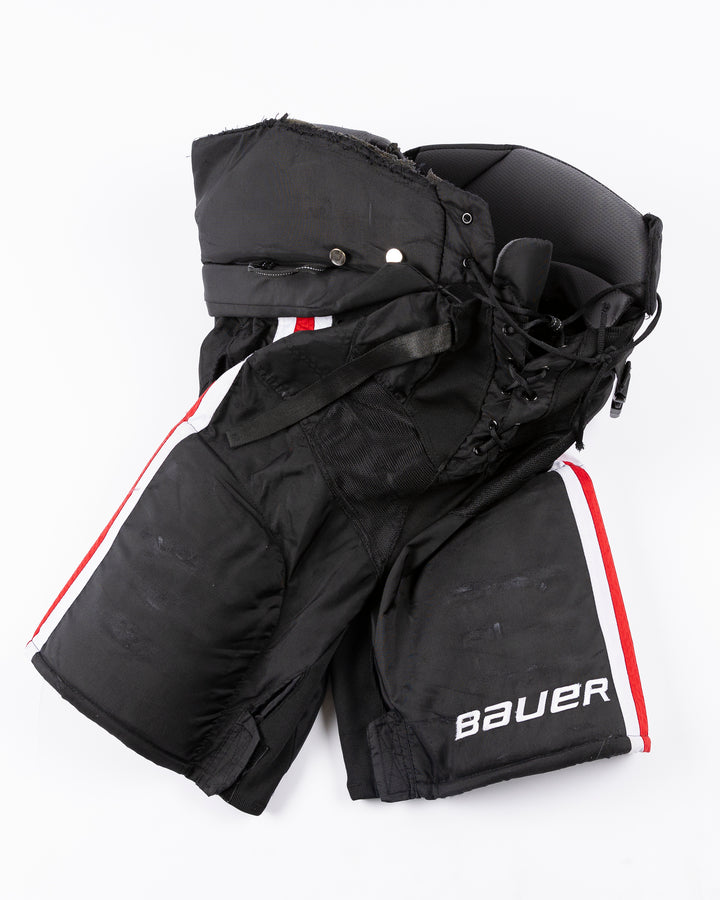 black Bauer hockey pants used by unspecified Chicago Blackhawks player - front lay flat