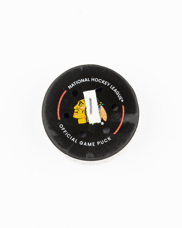 official Chicago Blackhawks hockey puck game used and scored by player Tyler Bertuzzi - front lay flat
