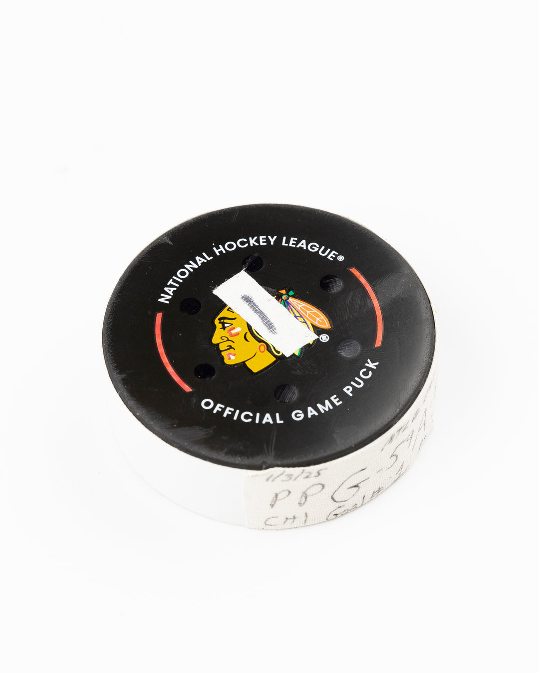 official Chicago Blackhawks hockey puck game used and scored by player Tyler Bertuzzi - front angle lay flat