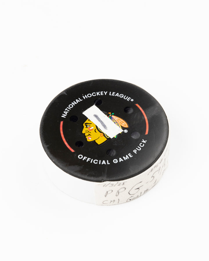 official Chicago Blackhawks hockey puck game used and scored by player Tyler Bertuzzi - front angle lay flat