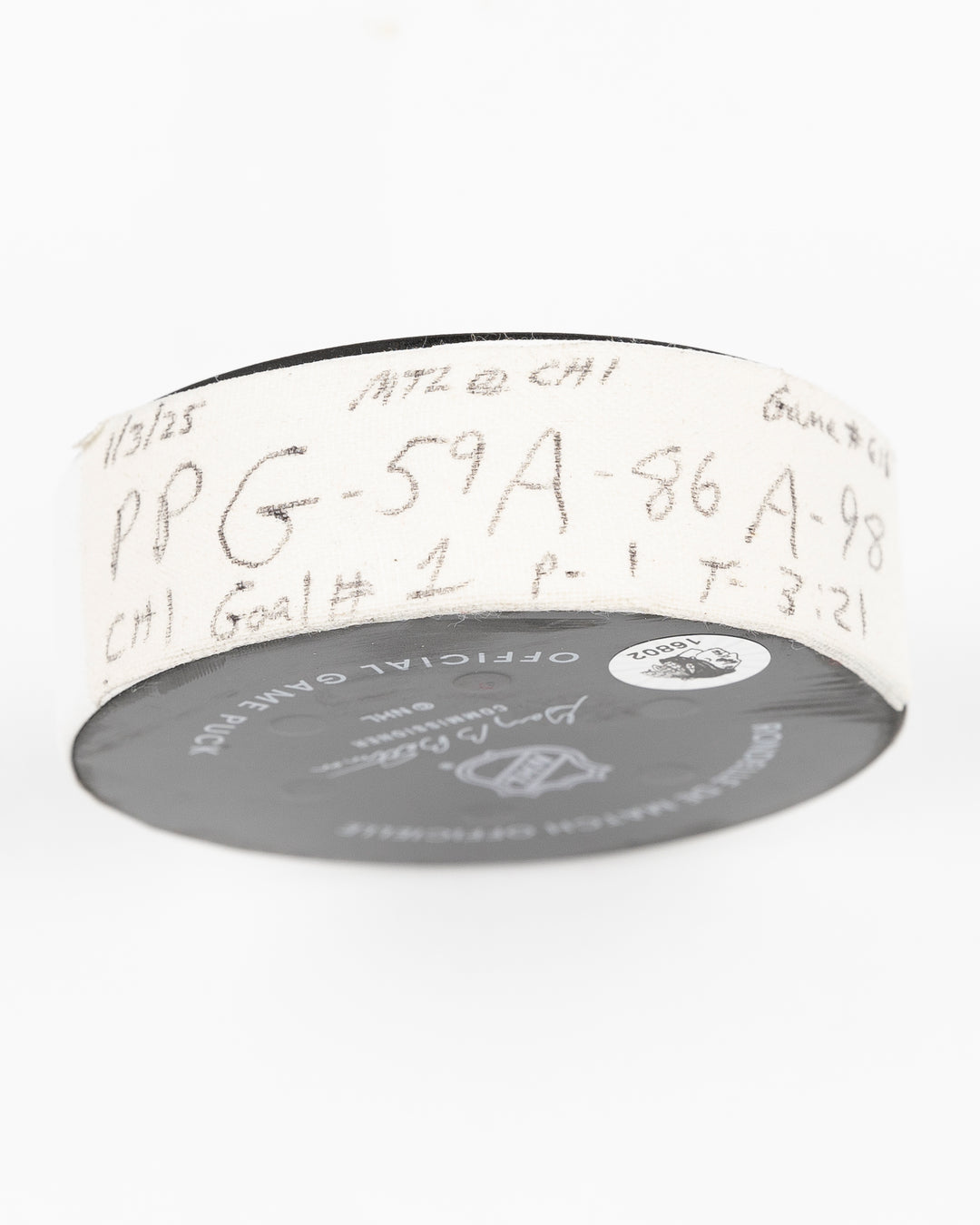 official Chicago Blackhawks hockey puck game used and scored by player Tyler Bertuzzi - tape detail lay flat