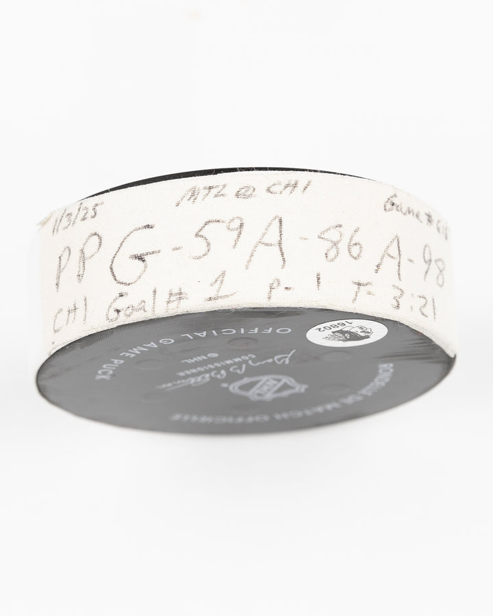 official Chicago Blackhawks hockey puck game used and scored by player Tyler Bertuzzi - tape detail lay flat