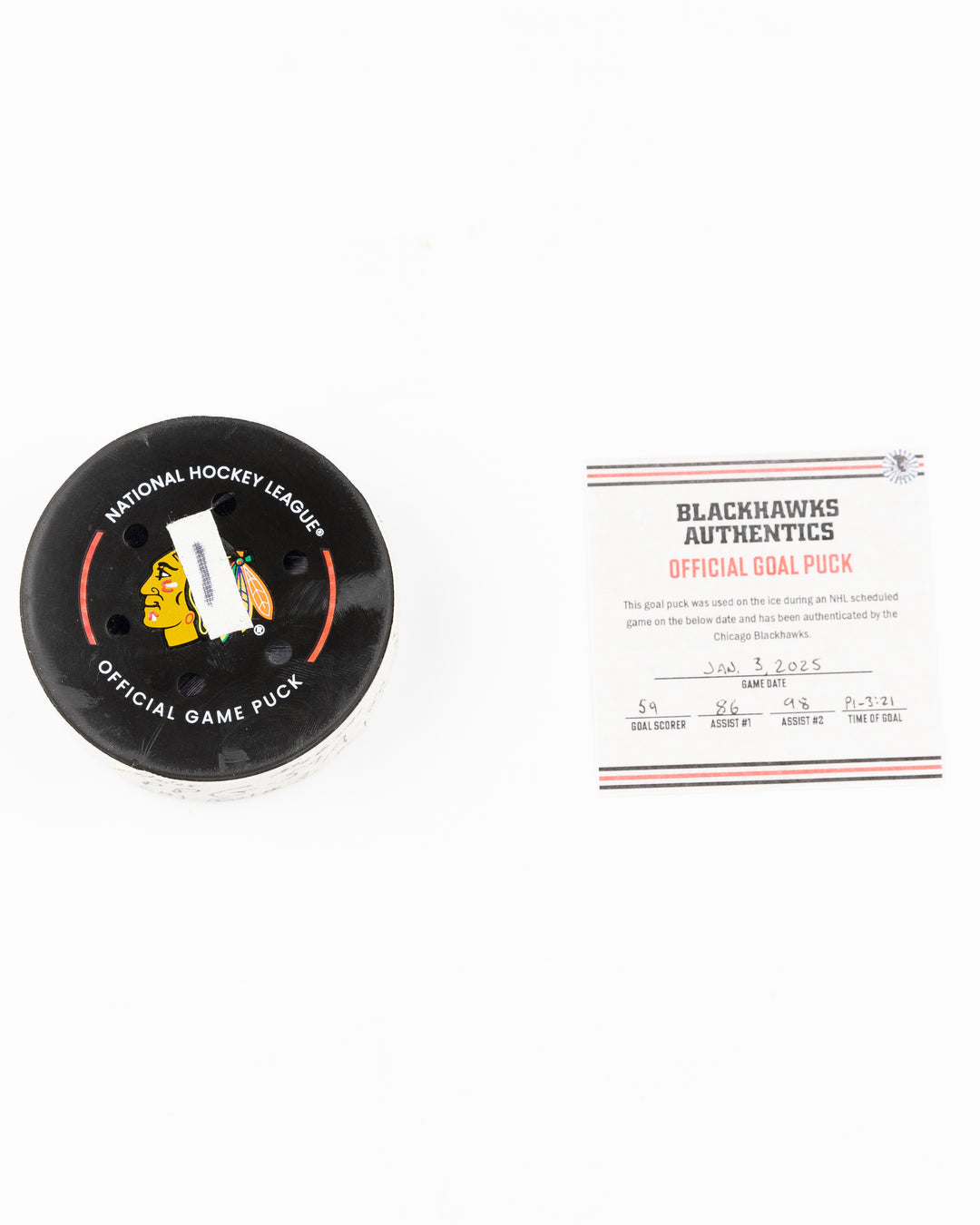 official Chicago Blackhawks hockey puck game used and scored by player Tyler Bertuzzi - puck and certificate lay flat