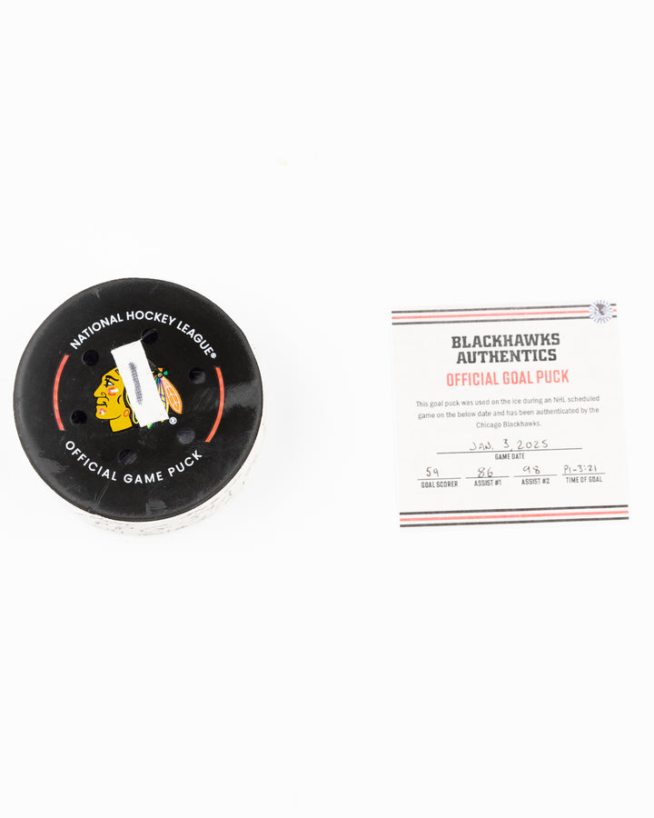 official Chicago Blackhawks hockey puck game used and scored by player Tyler Bertuzzi - puck and certificate lay flat