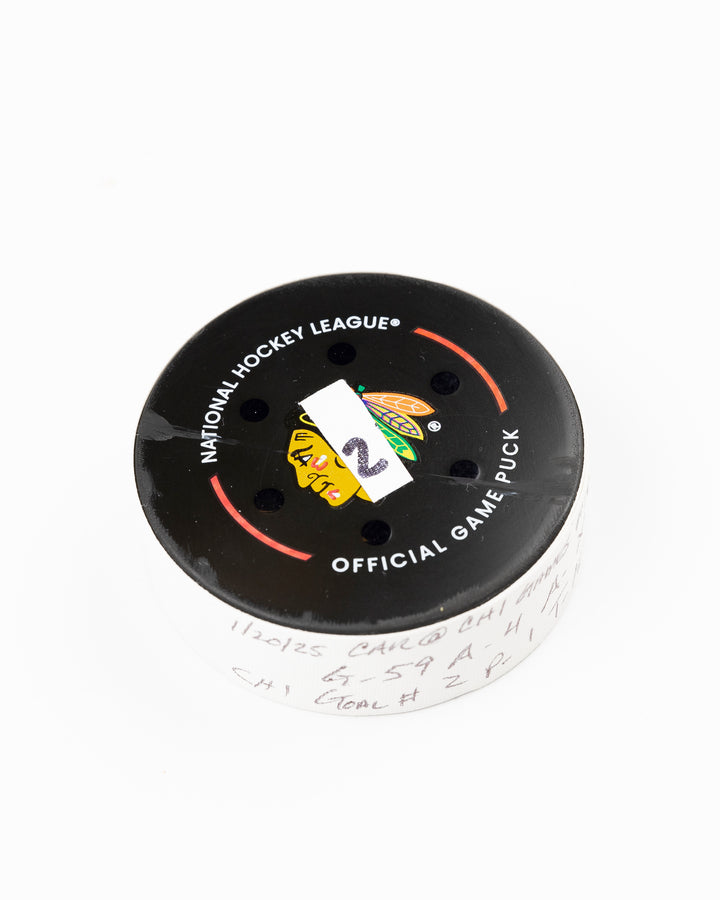 official Chicago Blackhawks game used goal puck scored by Tyler Bertuzzi against the Carolina Hurricanes on January 20, 2025 - front angle lay flat