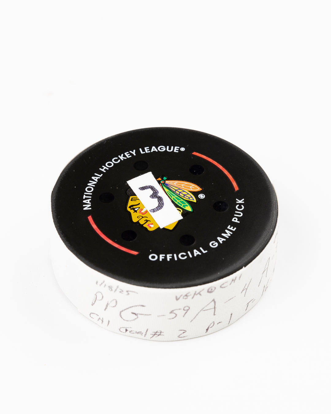 official Chicago Blackhawks game used goal puck scored by Tyler Bertuzzi against the Vegas Golden Knights on January 18, 2025 - front angle lay flat