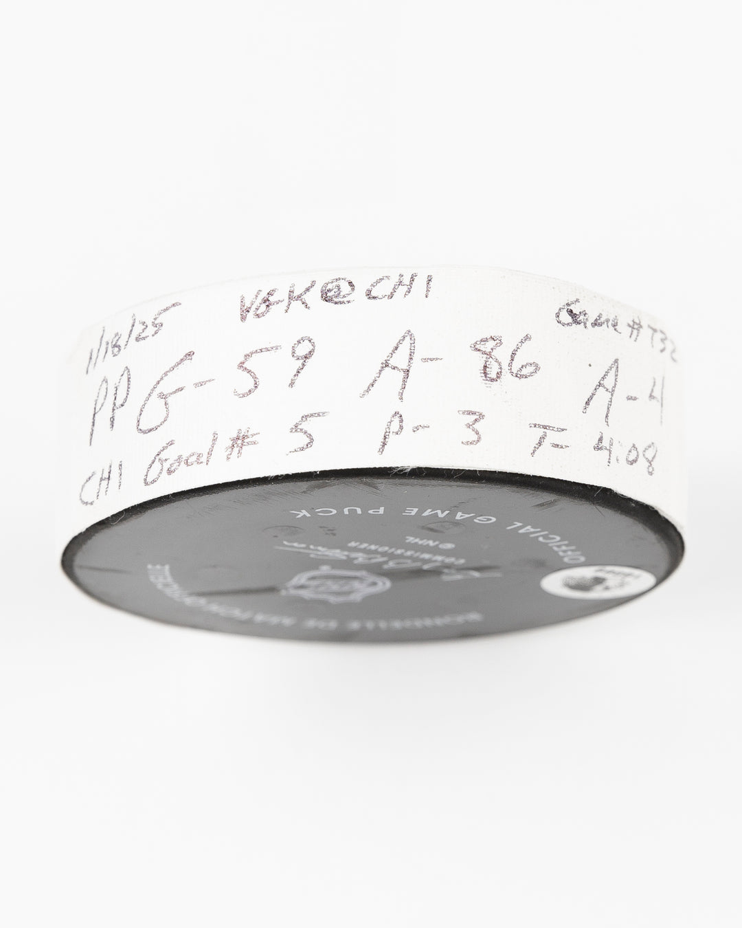 offcial Chicago Blackhawks game used goal hockey puck scored by Tyler Bertuzzi against Vegas Golden Knights on January 18, 2025 - tape detail lay flat