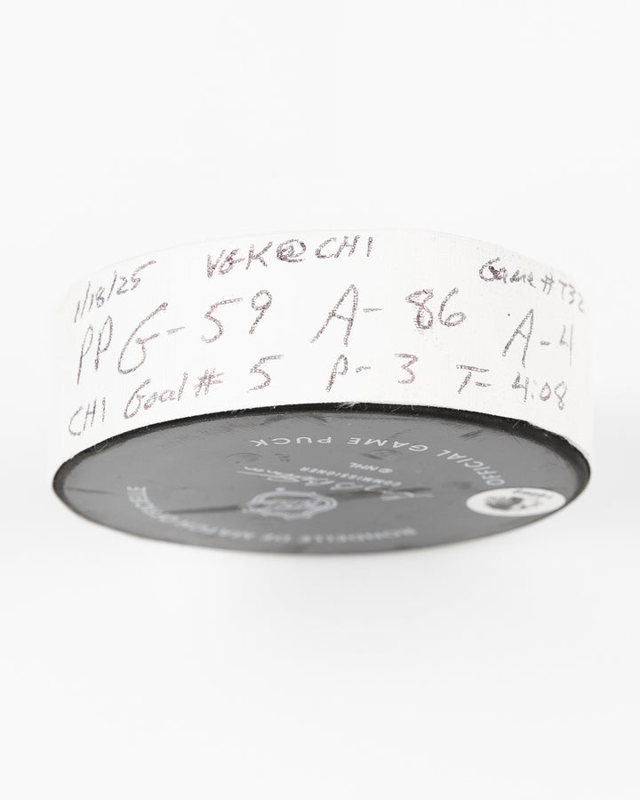 offcial Chicago Blackhawks game used goal hockey puck scored by Tyler Bertuzzi against Vegas Golden Knights on January 18, 2025 - tape detail lay flat