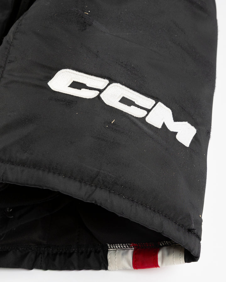 black CCM hockey pants used by Chicago Blackhawks player Ryan Donato - CCM detail lay flat