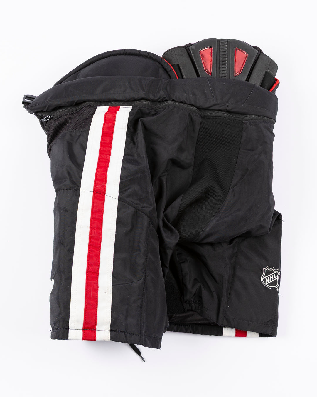 black CCM hockey pants used by Chicago Blackhawks player Ryan Donato - back lay flat
