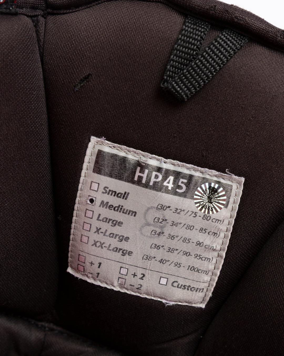 black CCM hockey pants used by Chicago Blackhawks player Ryan Donato - size tag detail lay flat