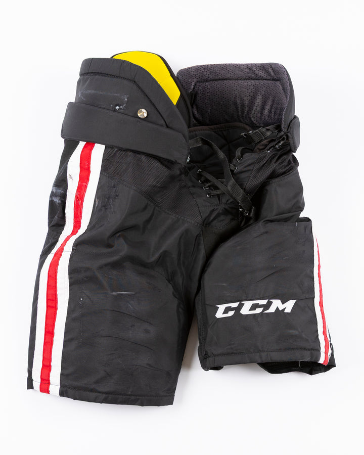 black CCM hockey pants used by Chicago Blackhawks player Jason Dickinson - front lay flat