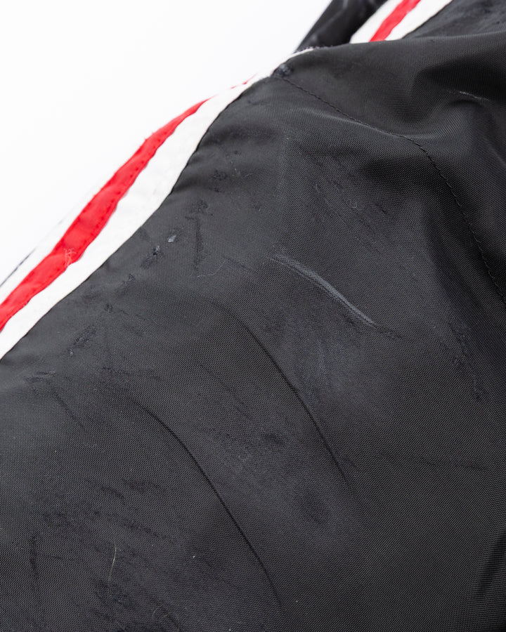 black CCM hockey pants used by Chicago Blackhawks player Jason Dickinson - distressing detail lay flat