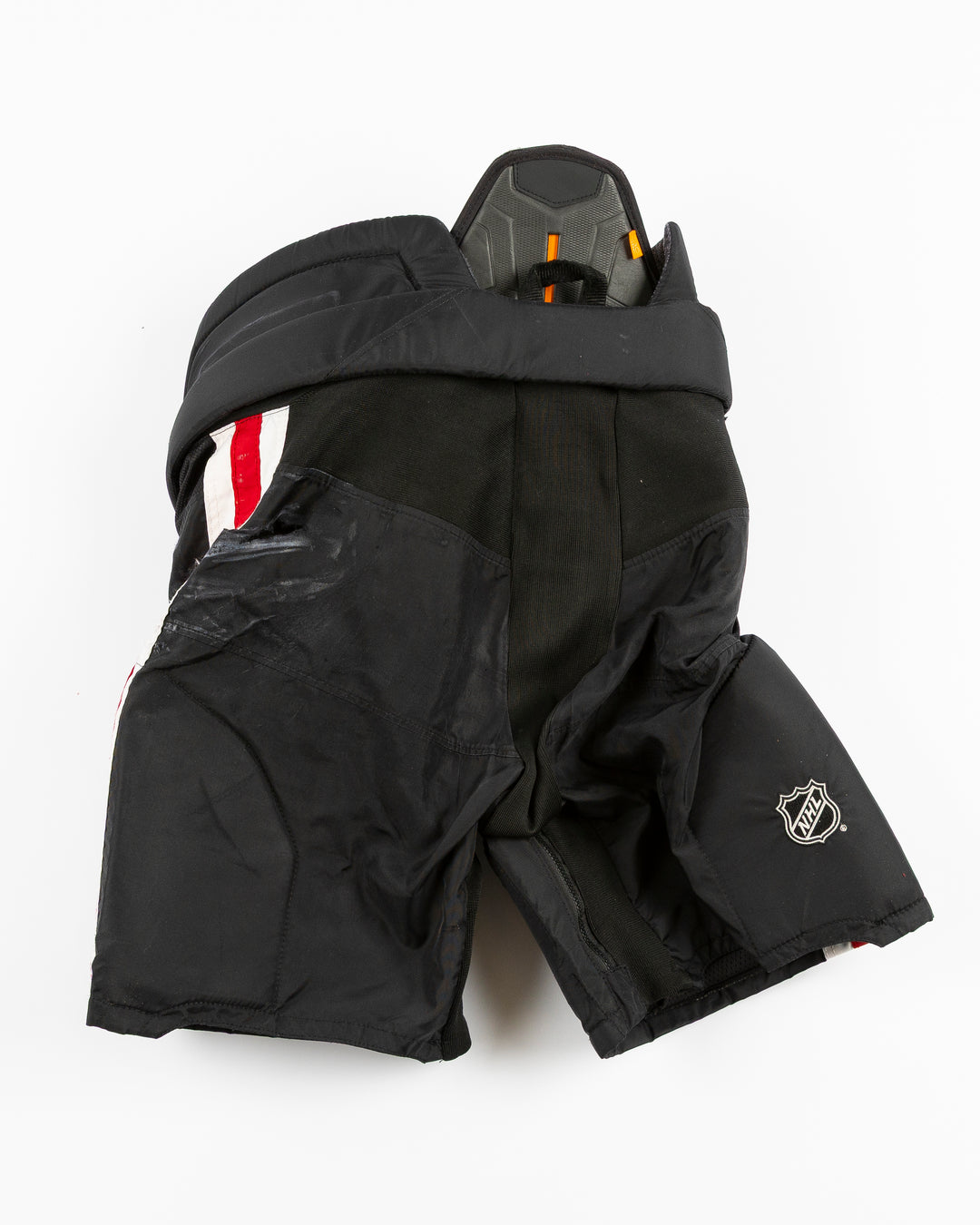 black CCM hockey pants used by Chicago Blackhawks player Jason Dickinson - back lay flat