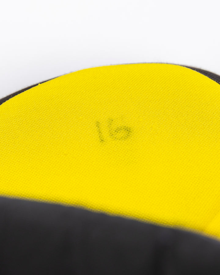 black CCM hockey pants used by Chicago Blackhawks player Jason Dickinson - number detail lay flat