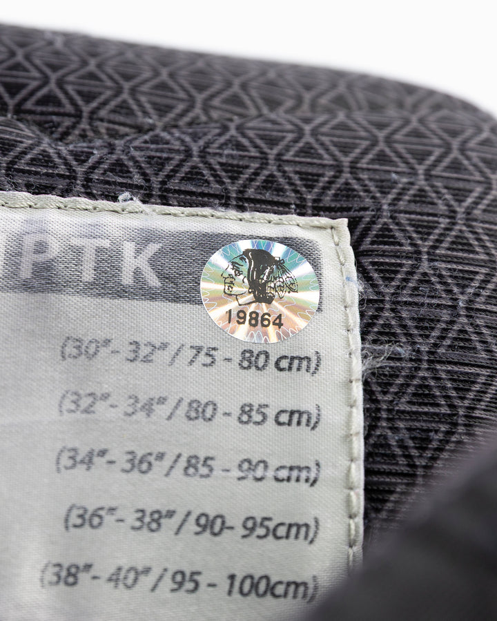 black CCM hockey pants used by Chicago Blackhawks player Jason Dickinson - hologram sticker detail lay flat