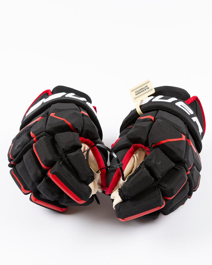 black Bauer hockey gloves used by Chicago Blackhawks player Pat Maroon - front lay flat