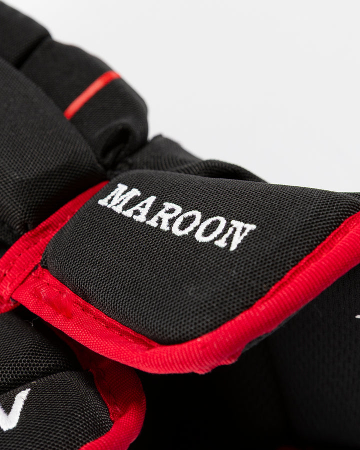black Bauer hockey gloves used by Chicago Blackhawks player Pat Maroon - name detail lay flat