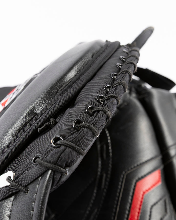 black hockey goalie glove Vaughn brand game used and game worn by former Chicago Blackhawks goalie Petr Mrazek - lace detail lay flat