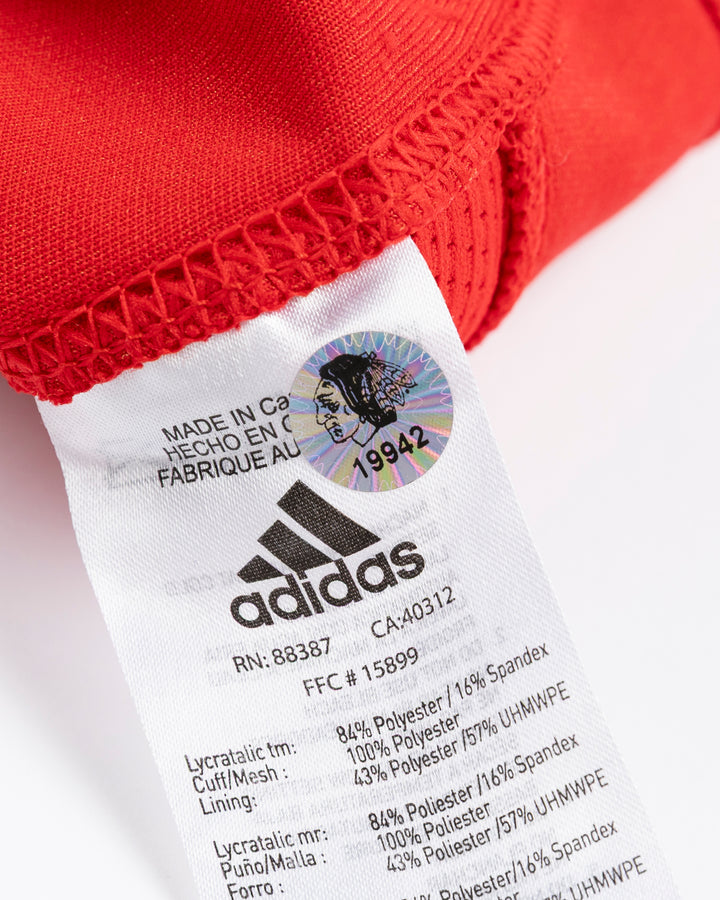 red adidas hockey socks used by Chicago Blackhawks player Nick Foligno - hologram sticker lay flat