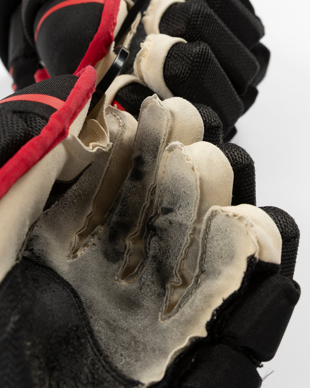 black Bauer hockey gloves used by Chicago Blackhawks player Craig Smith - palm detail lay flat