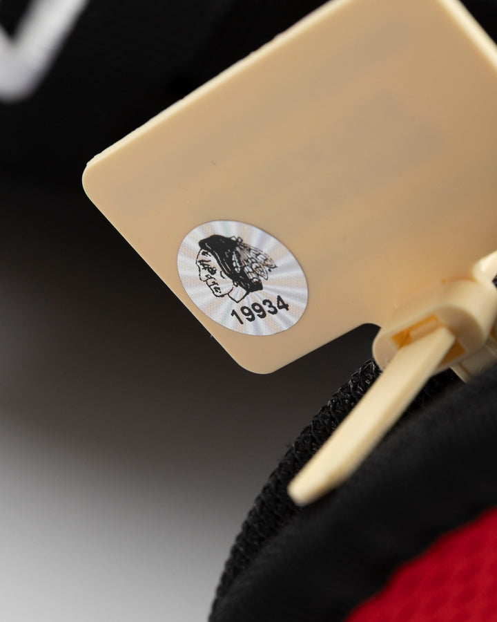 black Bauer hockey gloves used by Chicago Blackhawks player Taylor Hall - hologram sticker detail lay flat