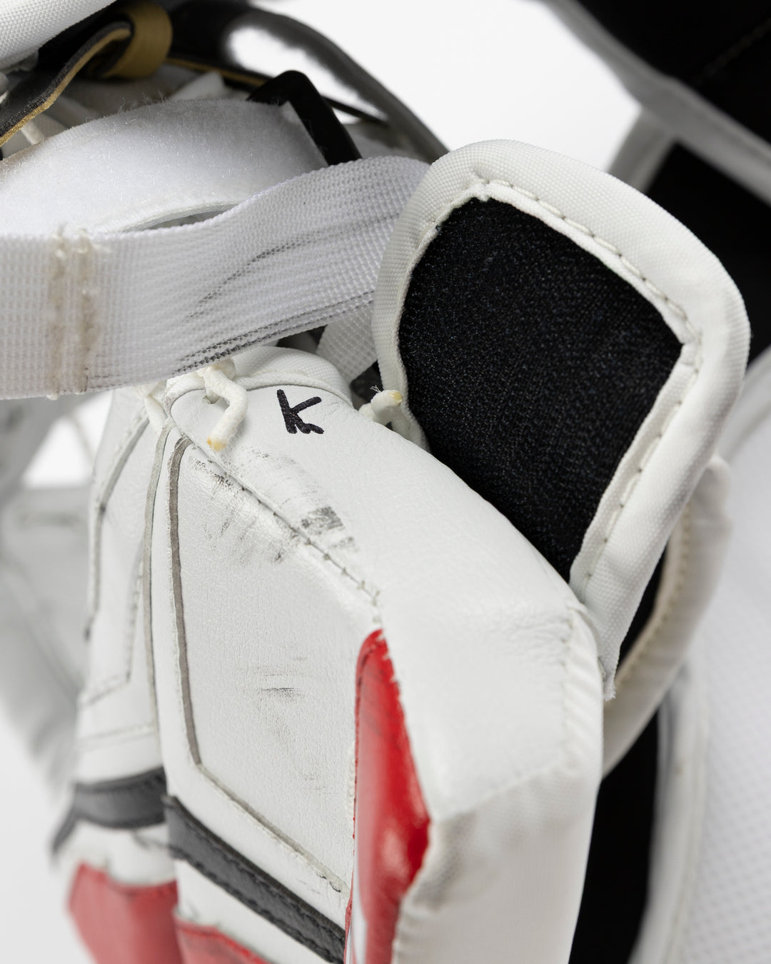 white and red Vaughn hockey goalie glove used by Chicago Blackhawks goalie Petr Mrazek - alt detail lay flat